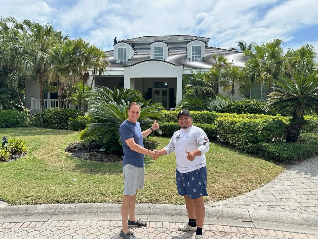 shaking hands with a happy homeowner after reroof